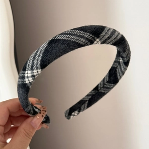 Close-up of retro black and white plaid headband with thick sponge padding and soft fabric