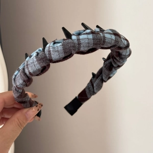 Detailed view of the anti-slip black plastic teeth inside the plaid fabric headband