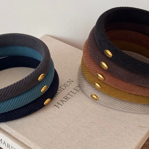 Minimalist wide padded headband with twill texture and golden oval logo in various colors