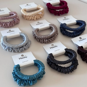 Set of premium satin hair scrunchies in various colors displayed on white cards