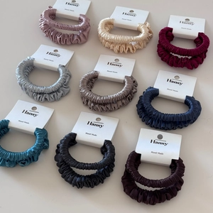 Detailed set of 9 pleated satin hair scrunchies in various colors on display cards