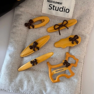 Yellow six-piece hair clip set with brown bows and dog shape minimalist accessories
