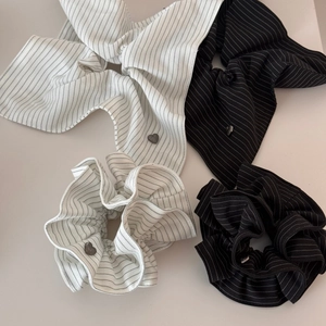 Striped fabric hair scrunchies with long ribbons and metal heart charms in black and white