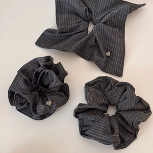 Set of grey striped scrunchies with silver metal heart details in minimalist style