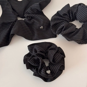 Detailed close-up of a 3-piece black striped hair accessory set with heart metal charms