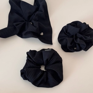 Detail showing navy striped fabric scrunchie set with handmade label and heart charm