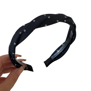 Navy blue twist headband with white polka dots and non-slip inner teeth for women