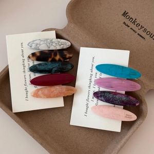 Vintage oval acetate hair clips in multiple colors with elegant marble and tortoiseshell patterns