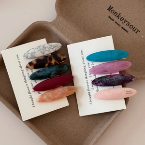 Oval acetate hair clips in 9 colors featuring marble and tortoiseshell patterns
