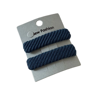 Set of two navy blue twill fabric hair clips for women on a display card