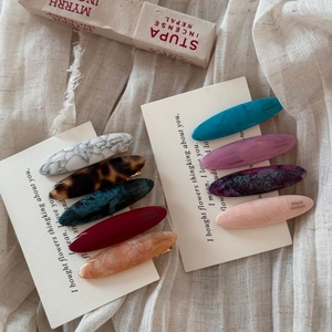 Set of retro acetate oval hair clips in marble and tortoiseshell patterns with duckbill clips
