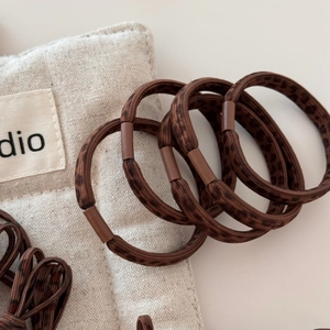 Leopard print hair tie set with brown matte buckle and canvas drawstring storage pouch