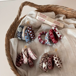 Detail of vintage jacquard knit hair scrunchies with retro patterns in a woven basket