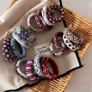 Close-up of assorted jacquard knit hair ties with detailed weaving and diverse patterns