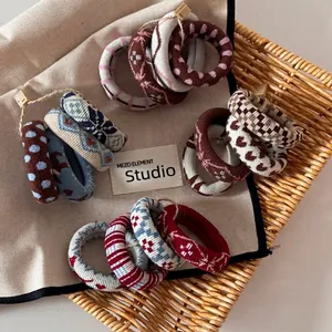 Jacquard knit scrunchies set with assorted vintage patterns in a woven basket