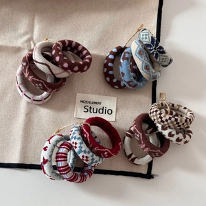 Set of four jacquard knit elastic hair ties in retro plaid, polka dot and striped patterns