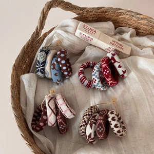 Detailed view of knitted jacquard hair scrunchies in various vintage patterns and colors