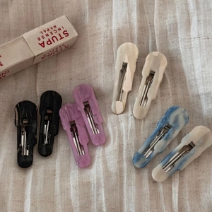Minimalist acetate hair clips in diverse colors like marble blue and lavender purple
