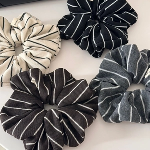 Set of four striped knitted hair scrunchies with Hand Made labels in neutral tones
