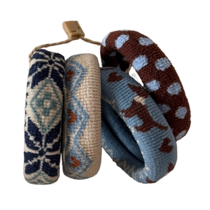 Set of four jacquard knit hair ties with geometric and animal patterns on white background