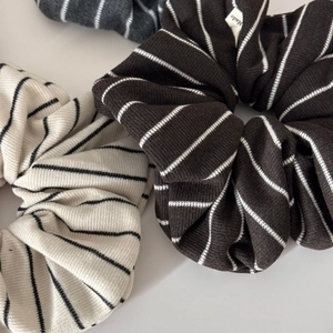 Detail of knitted striped scrunchies showing texture and premium fabric quality