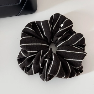 Detailed view of the black and white striped knit texture on a soft oversized scrunchie