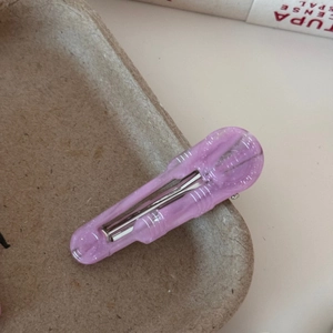 Macro shot of purple translucent acetate hair clip with fine glitter and metal spring