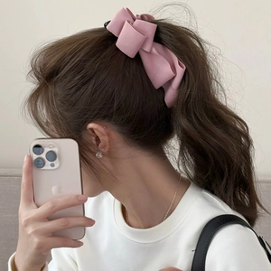 Pink suede layered bow banana hair clip for high ponytail accessory on female model