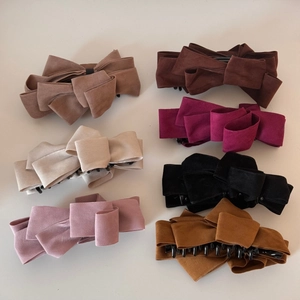 Detail showing seven colors of premium multi-layer velvet bow banana hair clips