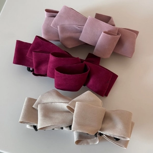 Three-piece set of layered suede bow banana clips in pink, burgundy, and off-white
