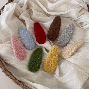 Eight colorful plush fleece BB hair clips in a woven basket for autumn winter