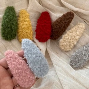 Set of eight colorful plush lamb wool BB hair clips for kids in various soft pastel colors