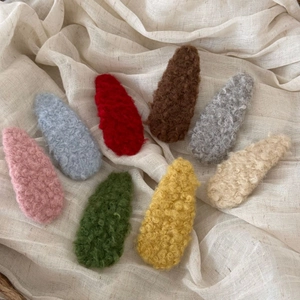 Detailed view of eight assorted soft lamb wool BB hair clips in diverse Morandi colors