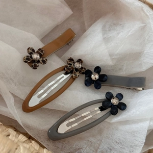 Vintage leopard acetate hair clips with rhinestone flowers and tortoiseshell patterns