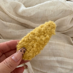 Close-up of a yellow faux lamb wool BB hair clip showing the soft curly plush texture