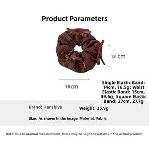 Detail view of coffee plaid fabric hair scrunchie with bows and 18cm size measurement