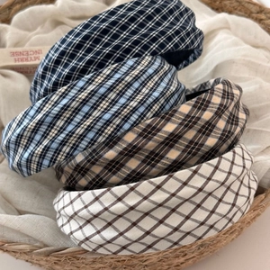 Detail view of plaid padded headbands in blue, brown and beige cotton fabric
