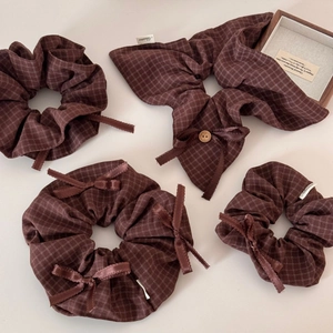 Brown plaid hair scrunchie set with ribbon bow and wooden button detail shown on white