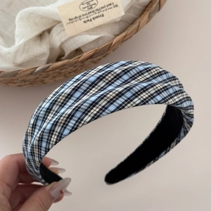 Detail shot of the blue checkered pattern fabric and thick padded edge of the headband
