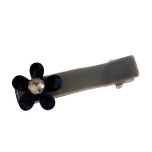 Vintage leopard acetate hair clip with rhinestone flower decoration on grey duckbill clip