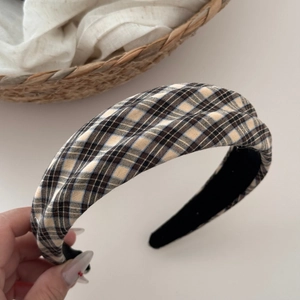 Detailed view of the vintage plaid headband with cross-knot design and fabric texture