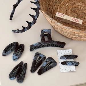 Close-up of blue and grey plaid fabric texture on handmade hair accessories set