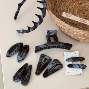 Close-up of blue and brown plaid fabric hair accessories set including clips and headband