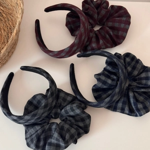Close-up of three retro plaid pleated wide headbands in grey, red, and blue fabrics
