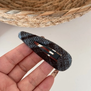Detailed view of blue and brown checkered fabric texture on a retro BB hair clip