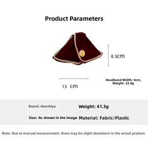 Detail view of burgundy velvet headband with gold woven trim and side metal button