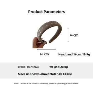 Close-up of brown bow-patterned oversized fabric hair scrunchie with size dimensions