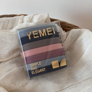 Close-up of high-elasticity hair ties in Morandi colors within a clear designer box