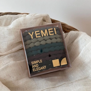 Detail view of high elasticity earth tone hair ties set in transparent square box packaging