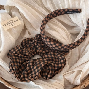 Close-up of handmade brown plaid fabric headband and oversized scrunchie hair set